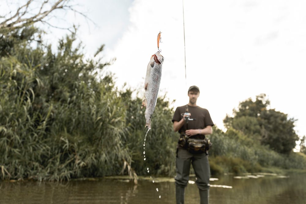 man fishing river